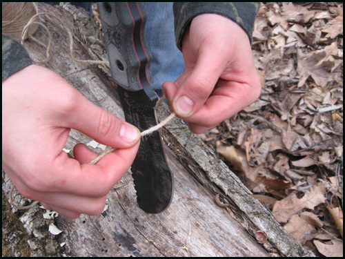 Stop Drop and Cut Now before you split too far into the wood, stop and cut a peice of cordage about four feet long. In this picture I am using natural jute twine, which is available at most hardware stores.